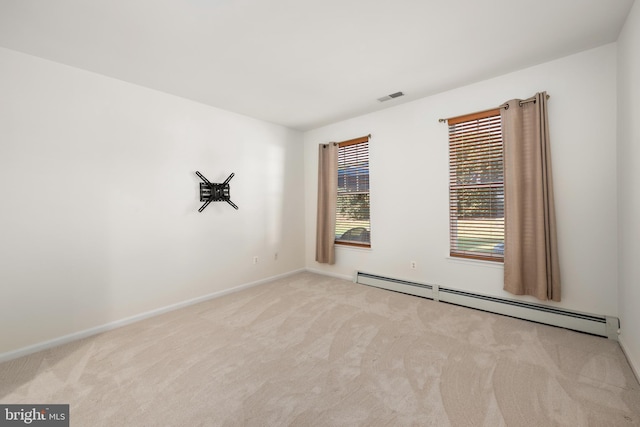 unfurnished room with light carpet and a baseboard radiator