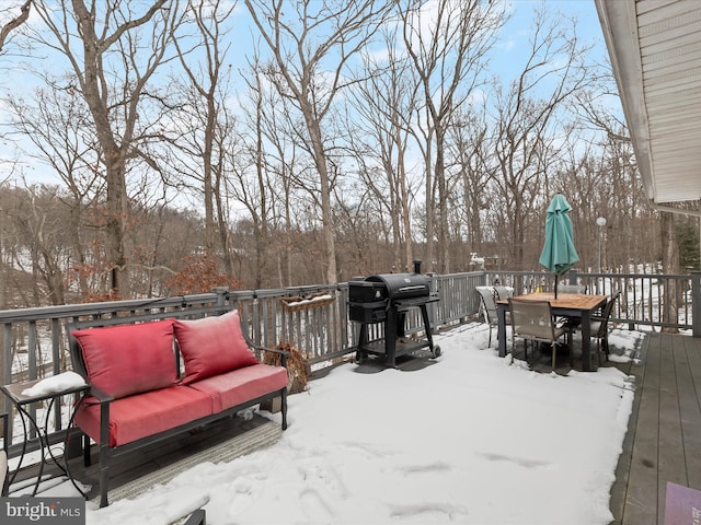 snow covered deck featuring area for grilling