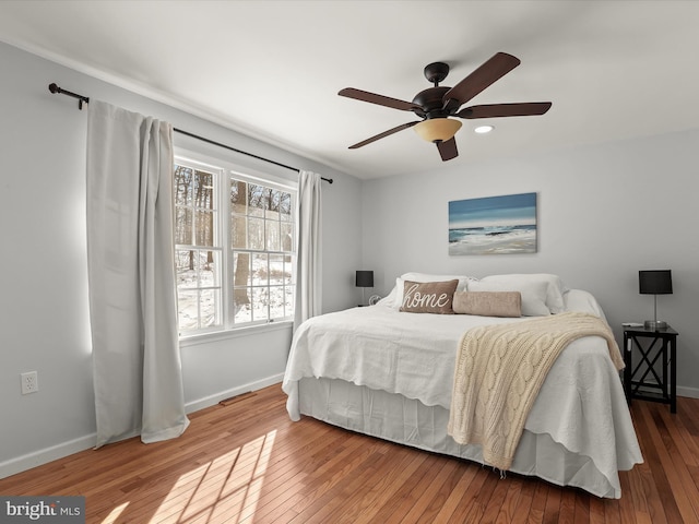 bedroom featuring wood-type flooring and ceiling fan