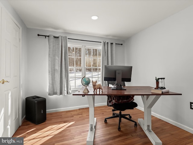 home office with light hardwood / wood-style floors