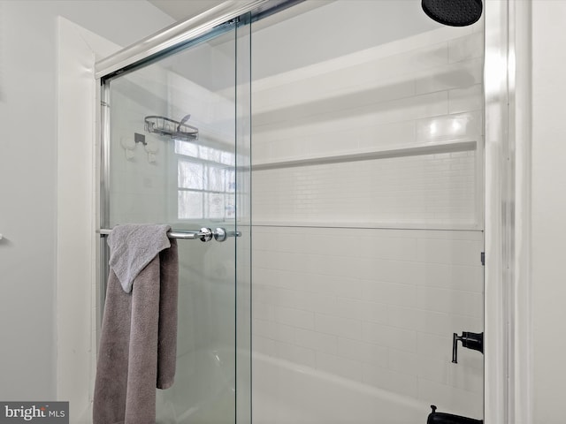 bathroom featuring bath / shower combo with glass door