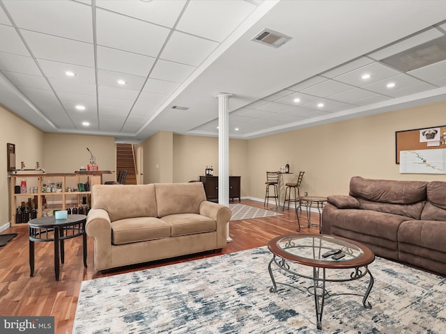 living room with ornate columns and wood-type flooring