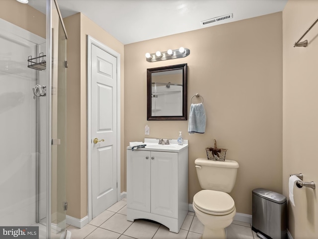 bathroom featuring vanity, toilet, tile patterned floors, and a shower with shower door