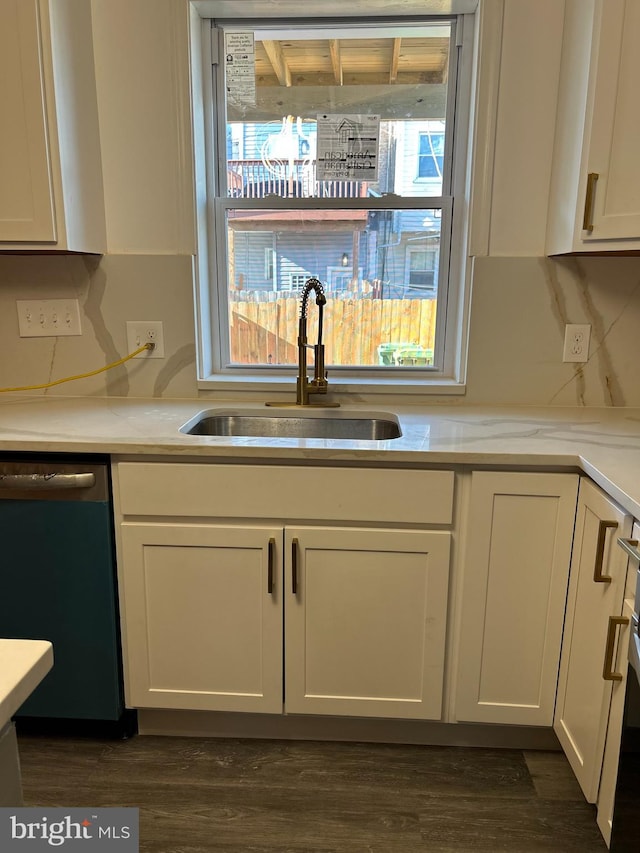 kitchen with dark wood-type flooring, white cabinetry, sink, and stainless steel dishwasher