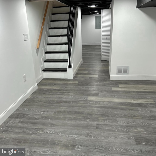 basement featuring dark hardwood / wood-style flooring