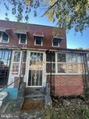 back of house featuring a sunroom