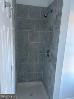 bathroom with tiled shower