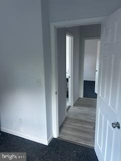 corridor with dark wood-type flooring