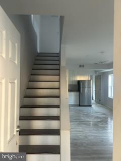 454 Roundview Rd, Baltimore, MD 21225 - stairway featuring wood finished floors