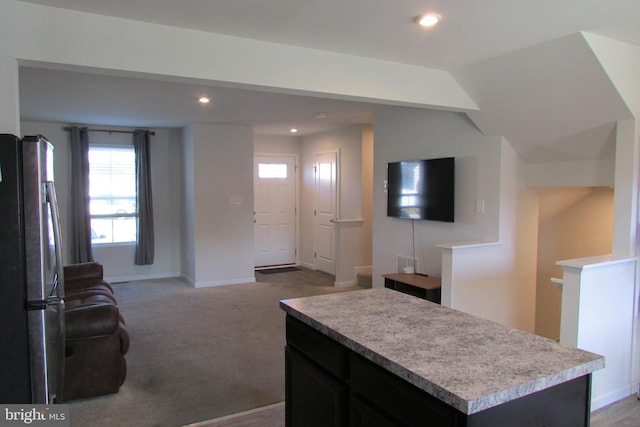 carpeted living room with lofted ceiling