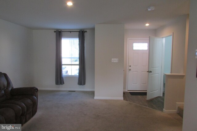 carpeted foyer with plenty of natural light