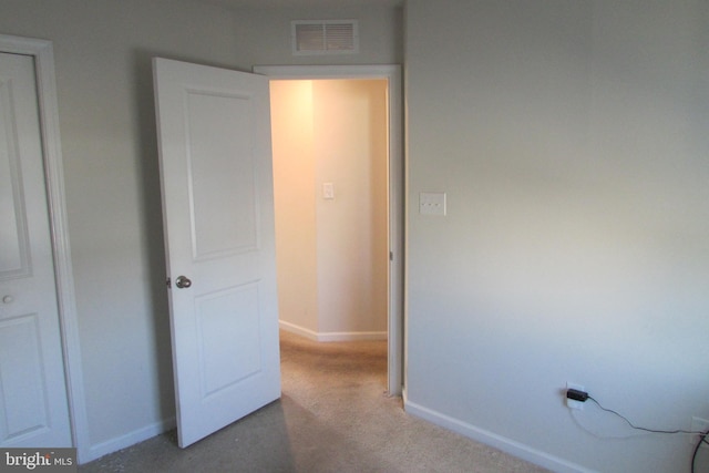 unfurnished bedroom with light carpet