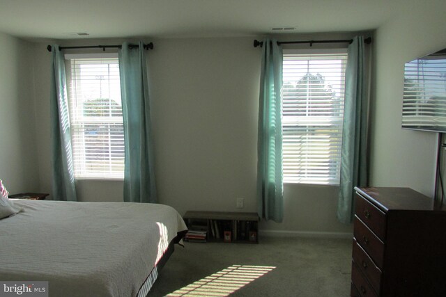 bedroom featuring light carpet