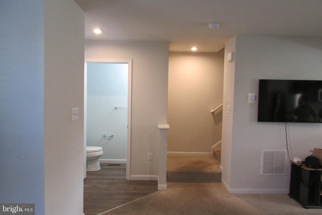 bathroom with hardwood / wood-style floors and toilet