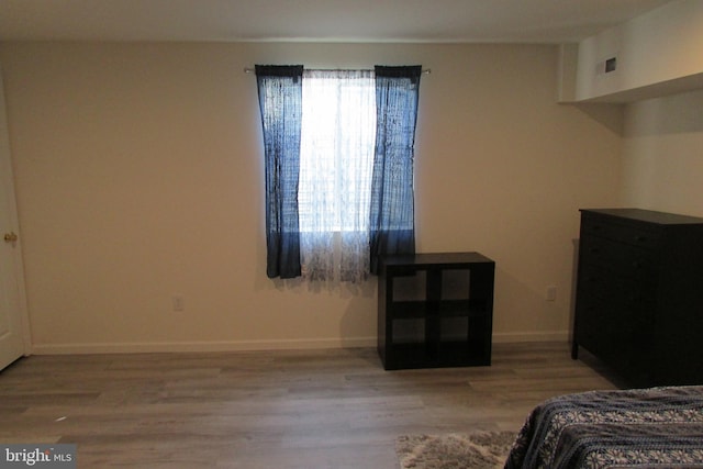 bedroom with hardwood / wood-style flooring