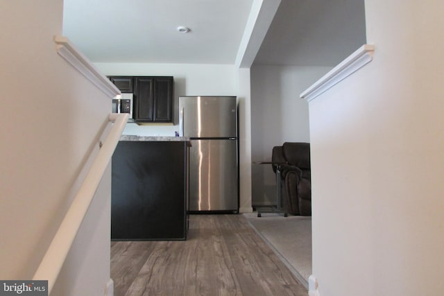 kitchen featuring hardwood / wood-style flooring and appliances with stainless steel finishes