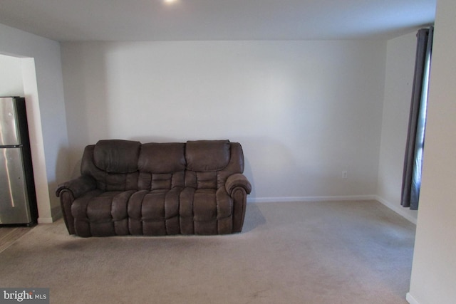 living area featuring light carpet