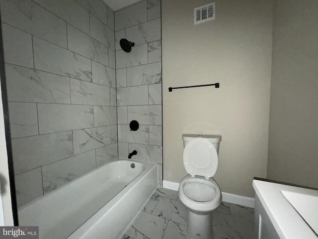 full bathroom featuring vanity, tiled shower / bath combo, and toilet