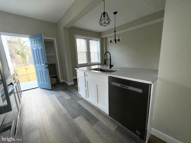 kitchen featuring sink, white cabinetry, decorative light fixtures, black dishwasher, and a wealth of natural light