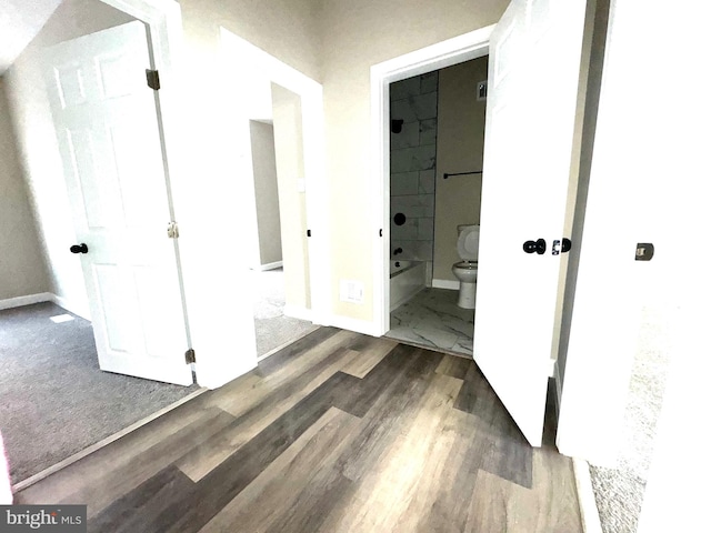 hallway featuring dark hardwood / wood-style flooring