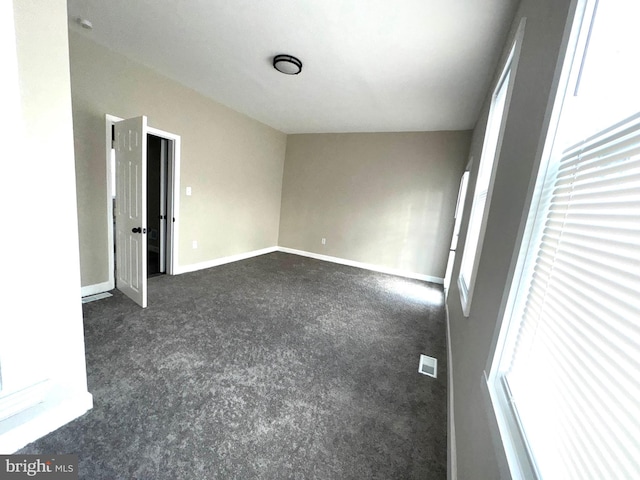 empty room featuring dark carpet