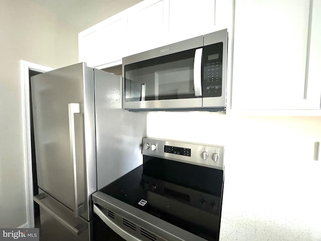 kitchen featuring white cabinetry and stainless steel appliances