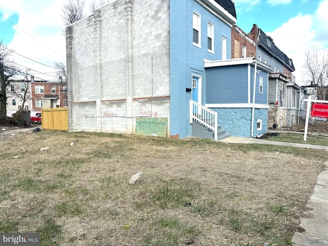 view of property exterior with a yard