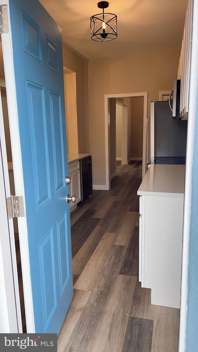 interior space with stainless steel appliances, dark wood-type flooring, and white cabinets