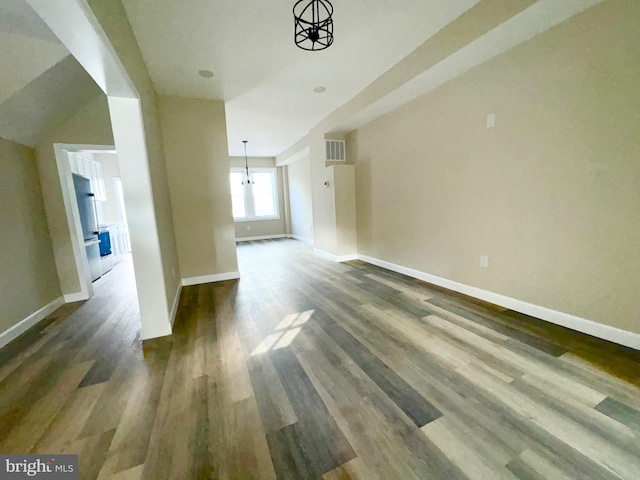 unfurnished living room with dark wood-type flooring