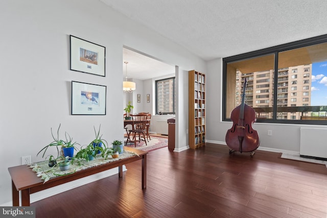 3701 S George Mason Dr Unit 1005N, Falls Church, VA 22041 - interior space featuring baseboards, a textured ceiling, wood finished floors, and radiator