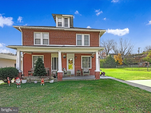 view of front of house with a porch and a front yard