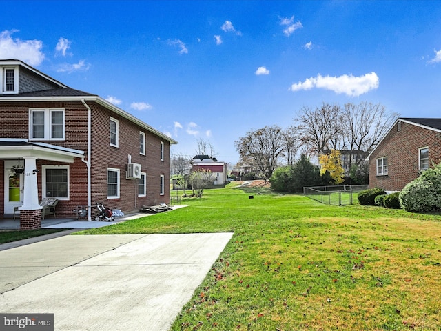 view of yard featuring a wall mounted air conditioner