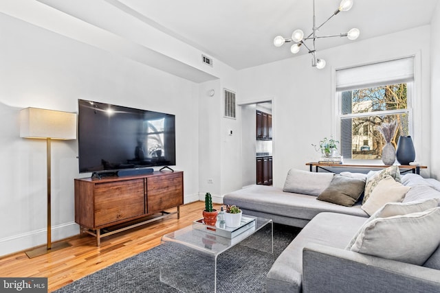 living room featuring hardwood / wood-style flooring and a chandelier