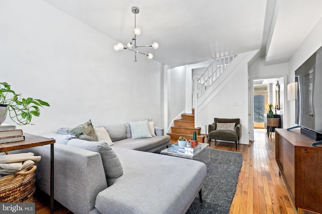 living room featuring a notable chandelier and wood-type flooring