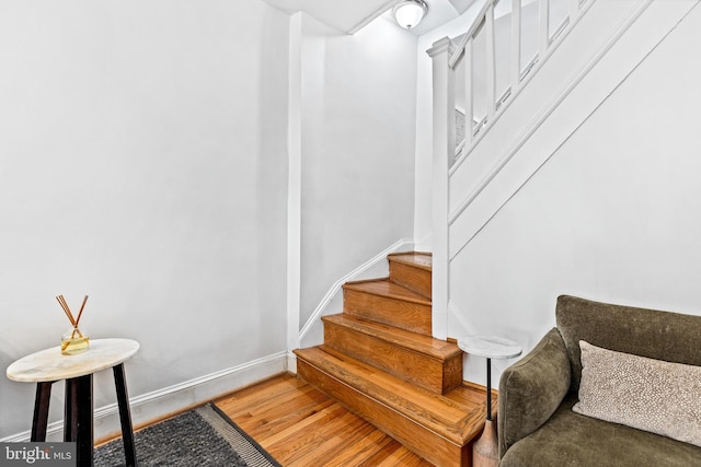 stairway featuring wood-type flooring