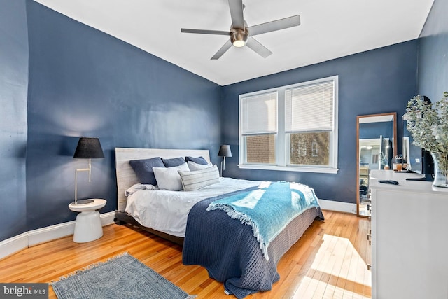 bedroom with hardwood / wood-style floors and ceiling fan