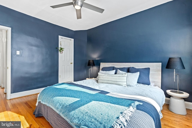 bedroom with wood-type flooring and ceiling fan