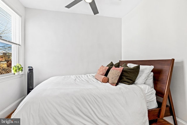 bedroom with wood-type flooring and ceiling fan