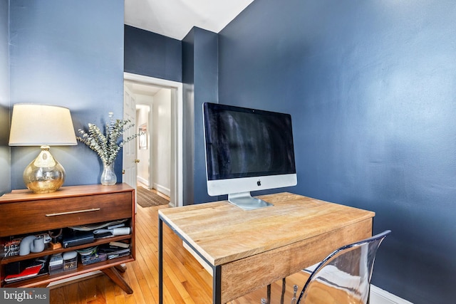 home office with wood-type flooring