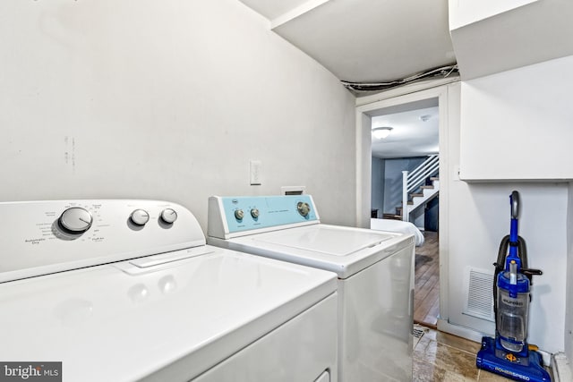 clothes washing area with washing machine and dryer