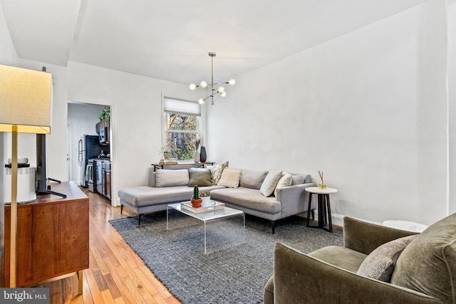 living room featuring an inviting chandelier and hardwood / wood-style floors