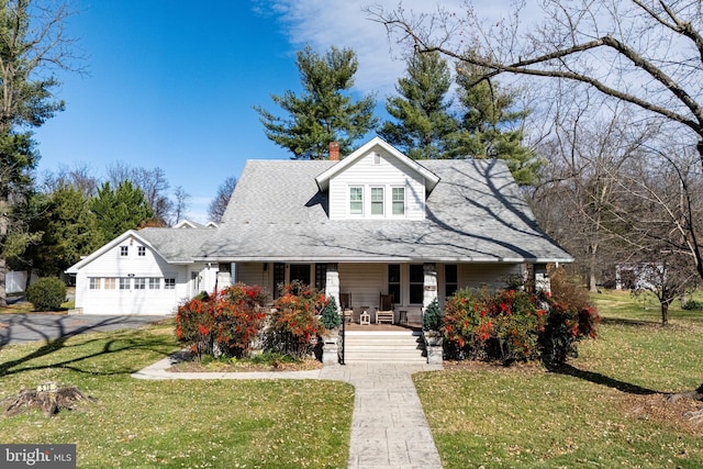 view of front of property with a porch and a front lawn