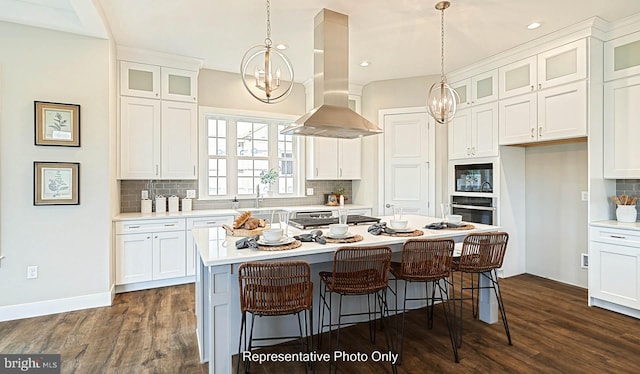 kitchen featuring a kitchen island, white cabinetry, dark wood-type flooring, and island range hood