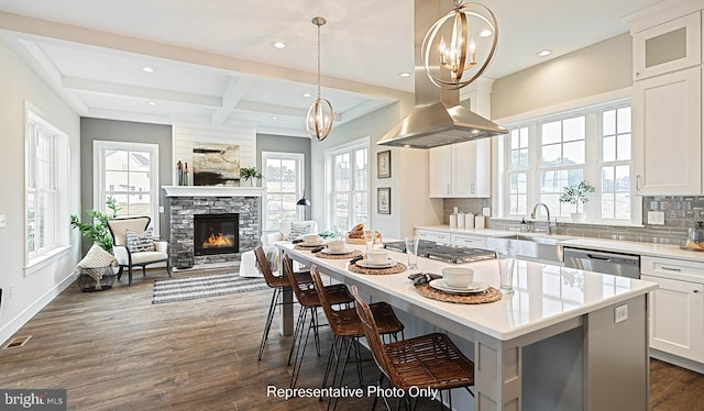 kitchen featuring a center island, sink, tasteful backsplash, dark hardwood / wood-style flooring, and white cabinets