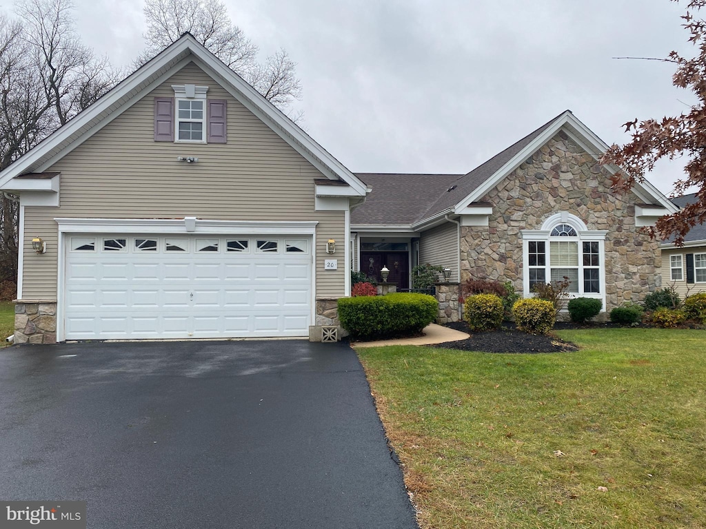 view of front property featuring a garage and a front yard