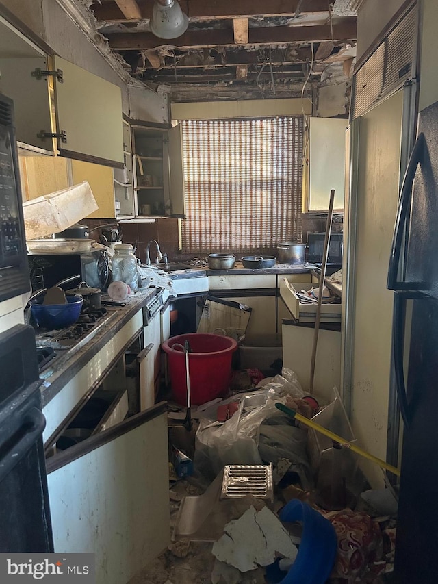 kitchen featuring oven, fridge, and sink