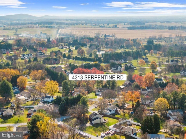 birds eye view of property with a mountain view