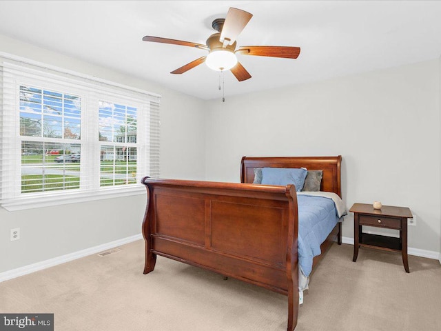 bedroom featuring ceiling fan and light carpet