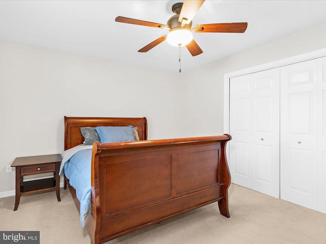 bedroom featuring light carpet, a closet, and ceiling fan