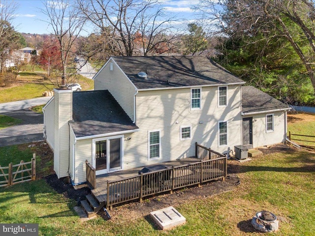 back of house with a lawn, a wooden deck, and cooling unit